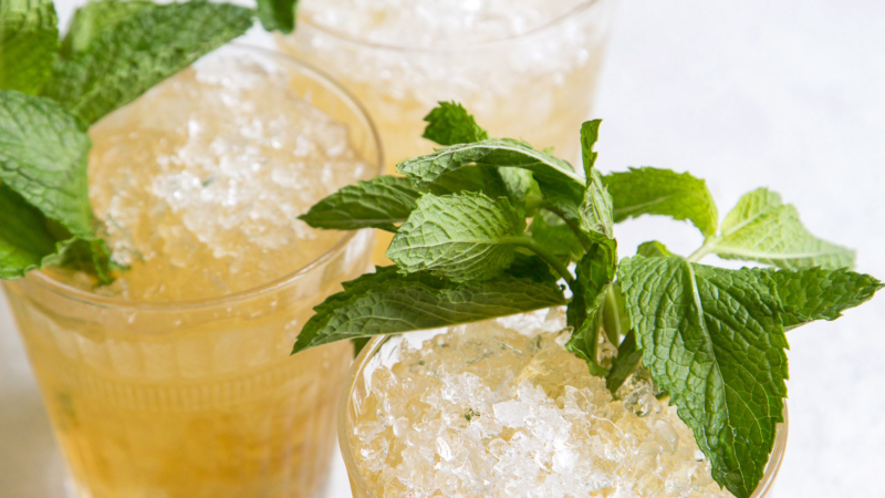 close up of three mint julep cocktails garnished with fresh mint