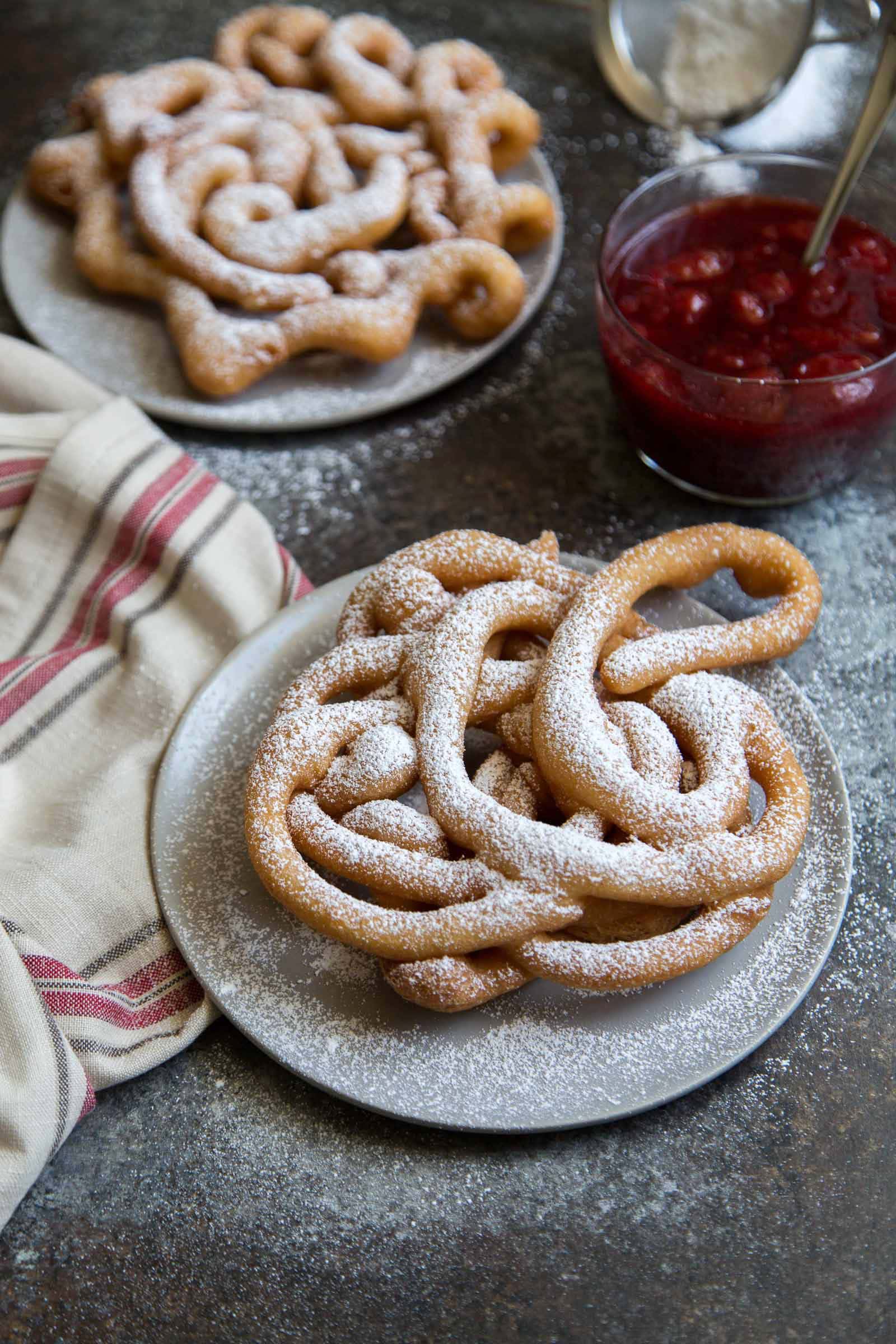 homemade funnel cake dusted with powdered sugar.
