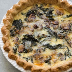Mushroom Kale Quiche in white pie plate.