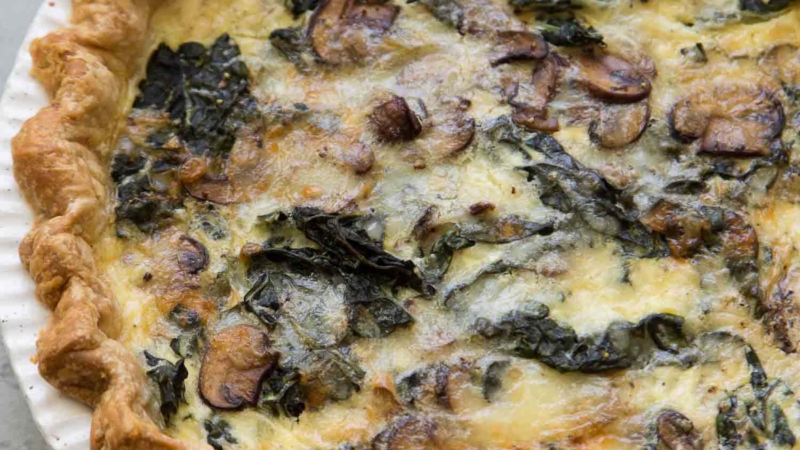 Mushroom Kale Quiche in white pie plate.