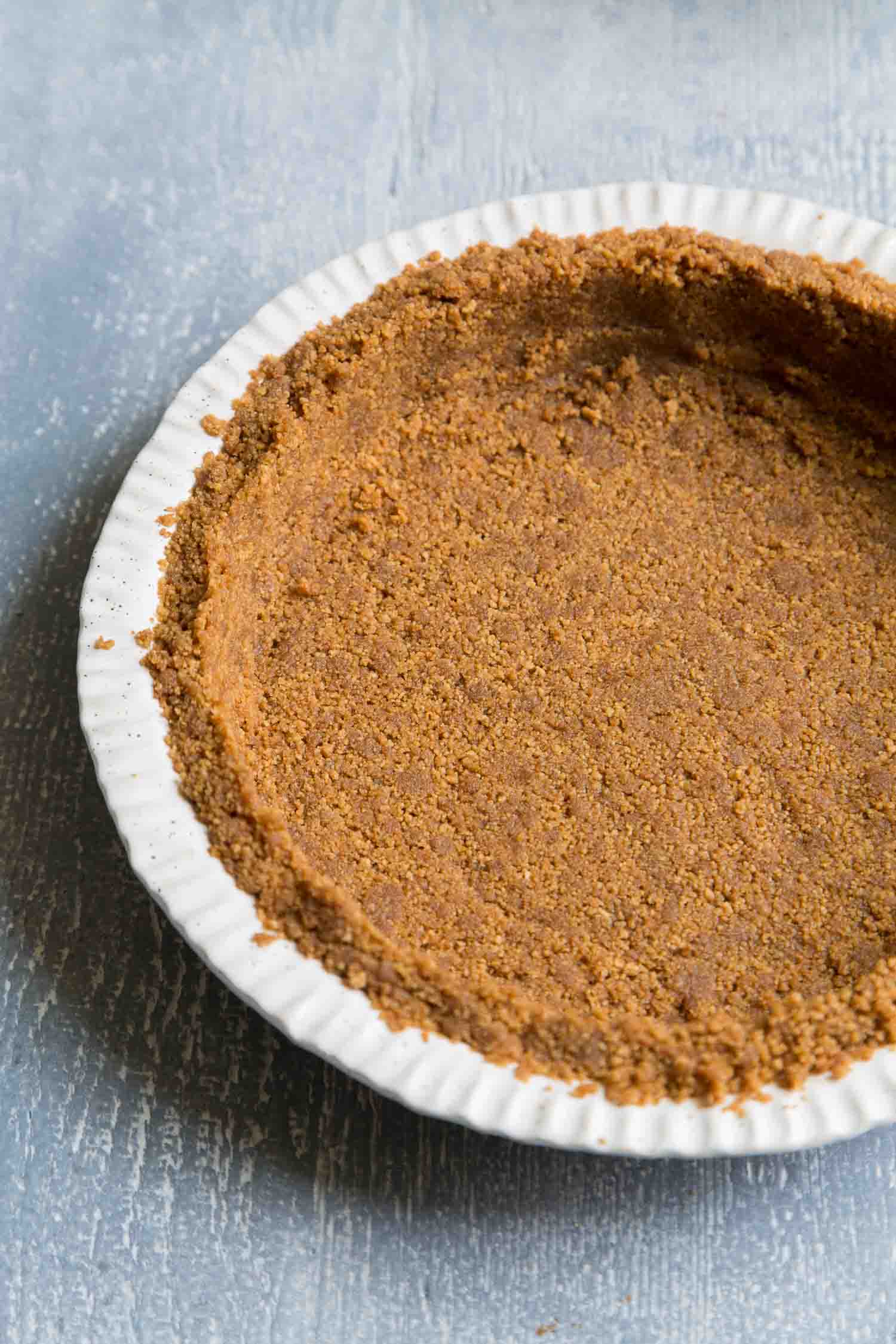 gingersnap cookie crust in white pie plate. 