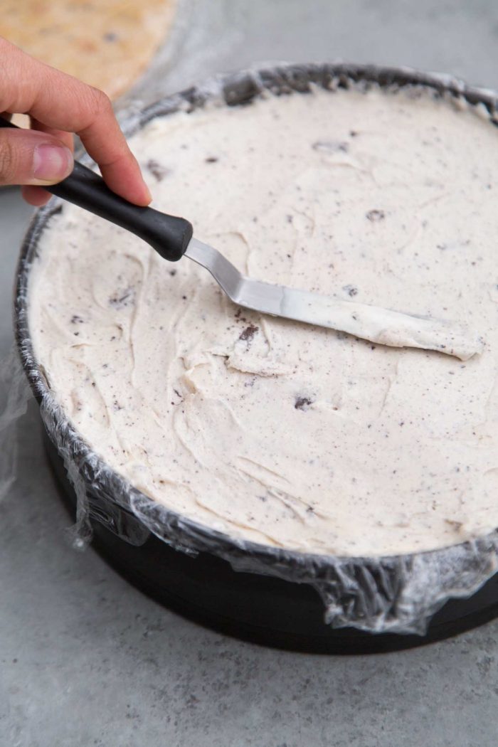 Layered ice cream cake smooth out with mini offset spatula.