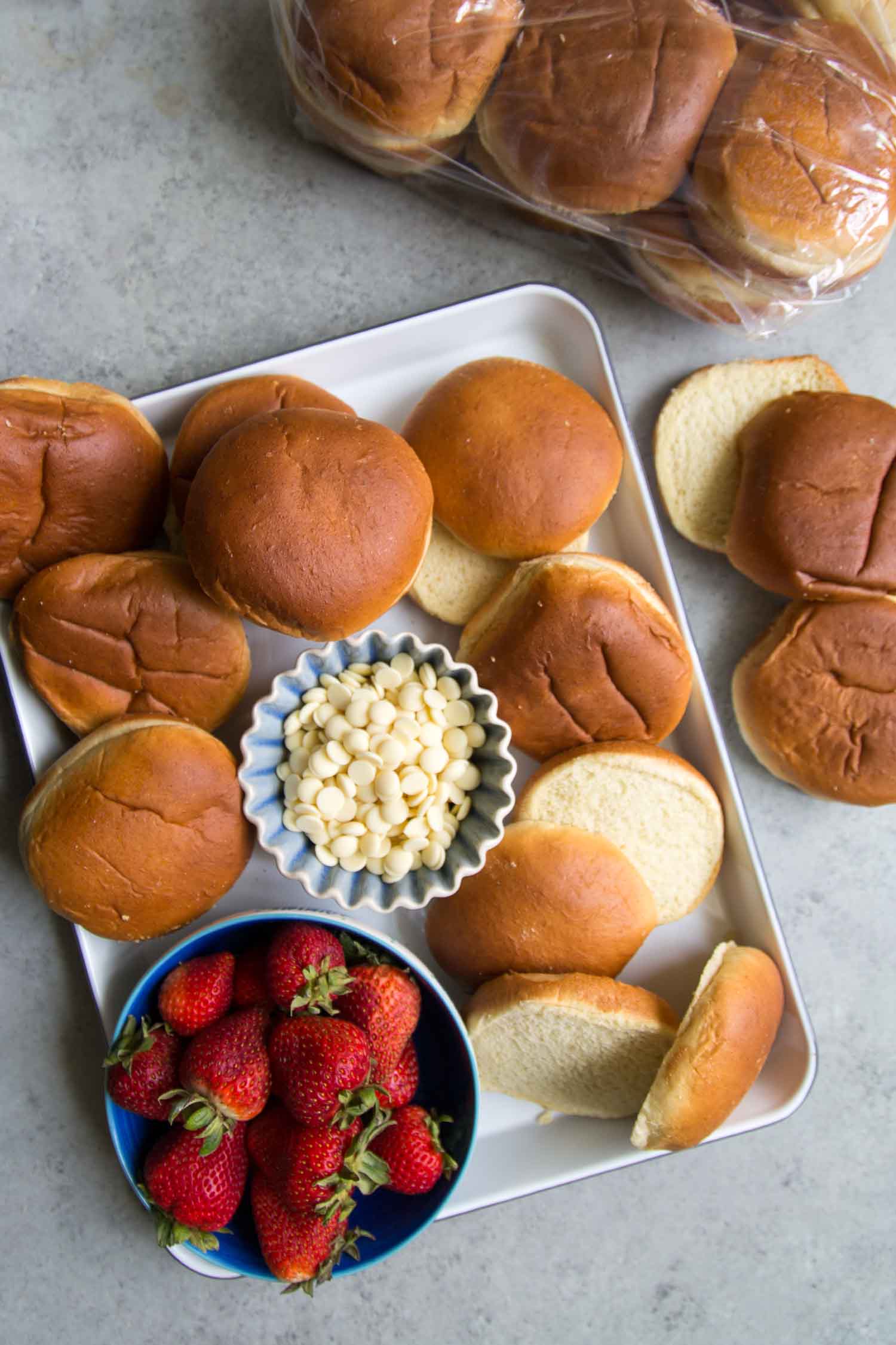 strawberry bread pudding ingredients include bread of choice such as hamburger buns, fresh strawberries, and white chocolate chips. 