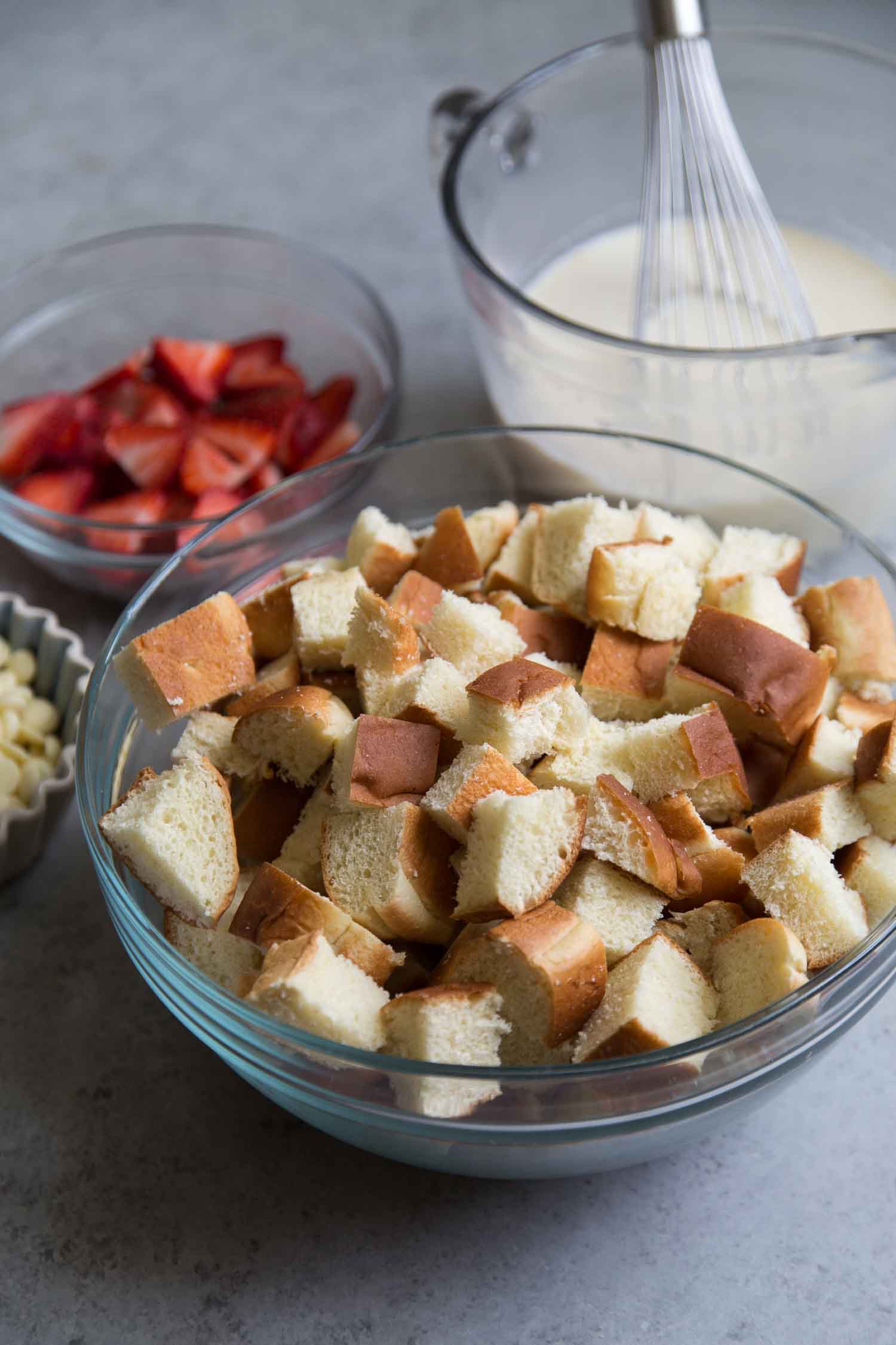 a large bowl of cubed bread ready for bread pudding assembly. 