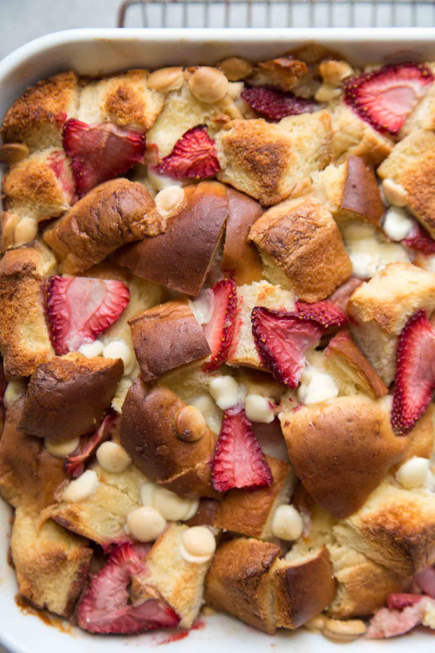 close up of strawberry bread pudding with white chocolate chips. 