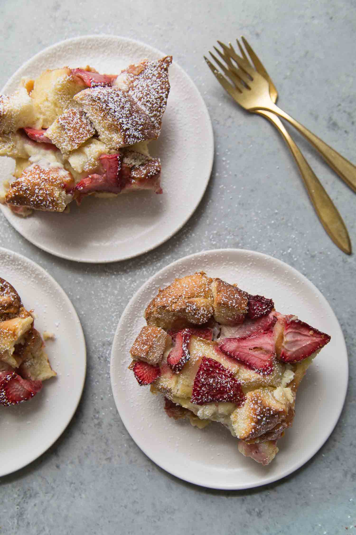 servings on strawberry bread on white dessert plates. 