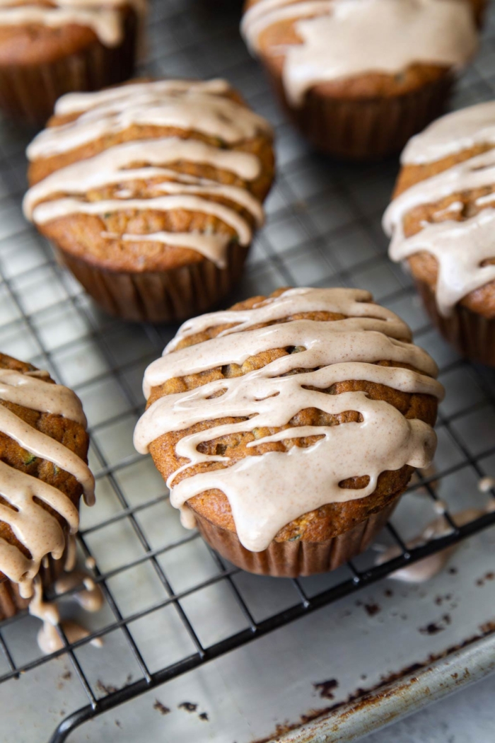 zucchini banana muffins on wire rack topped with spiced glaze.