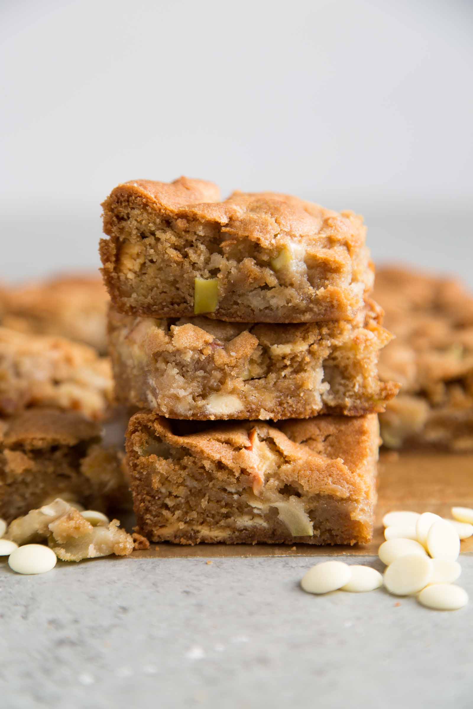 stack of three apple blondies bars on parchment paper. 