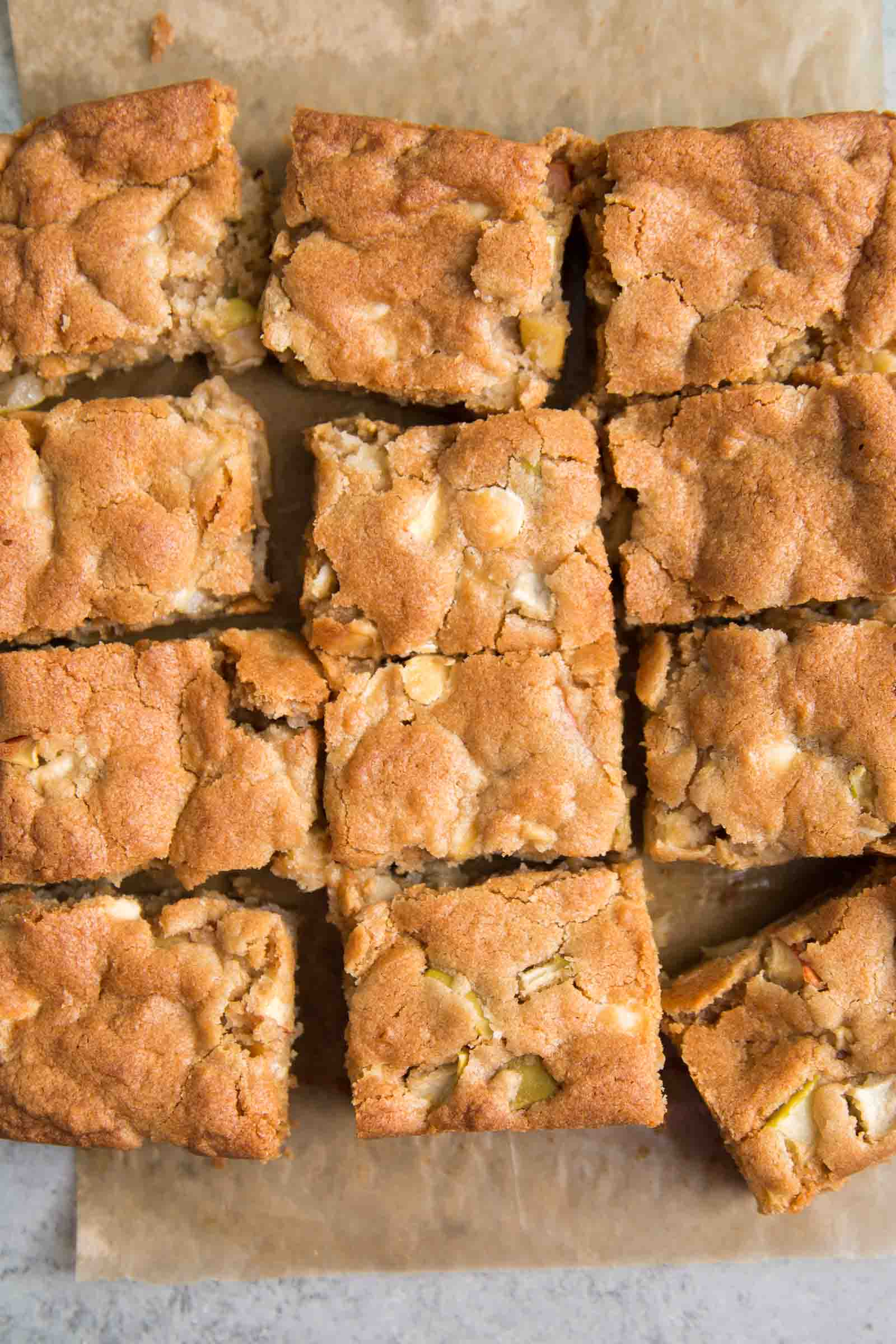 sliced apple blondie bars on natural parchment paper. 
