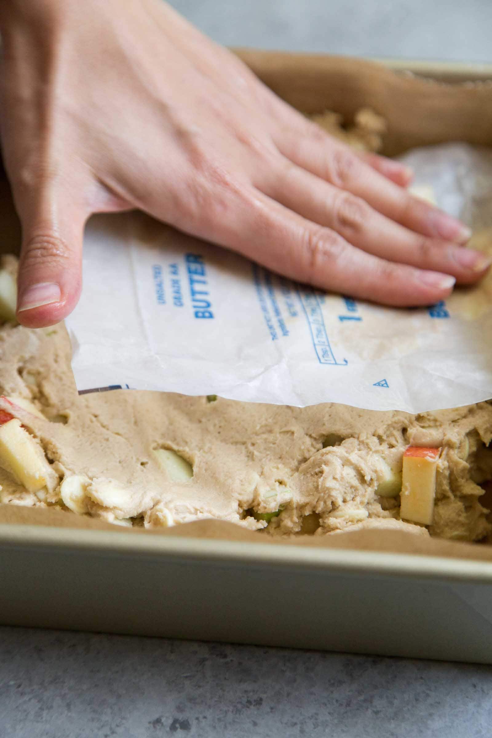 use greased butter wrapper to flatten the apple blondie batter.