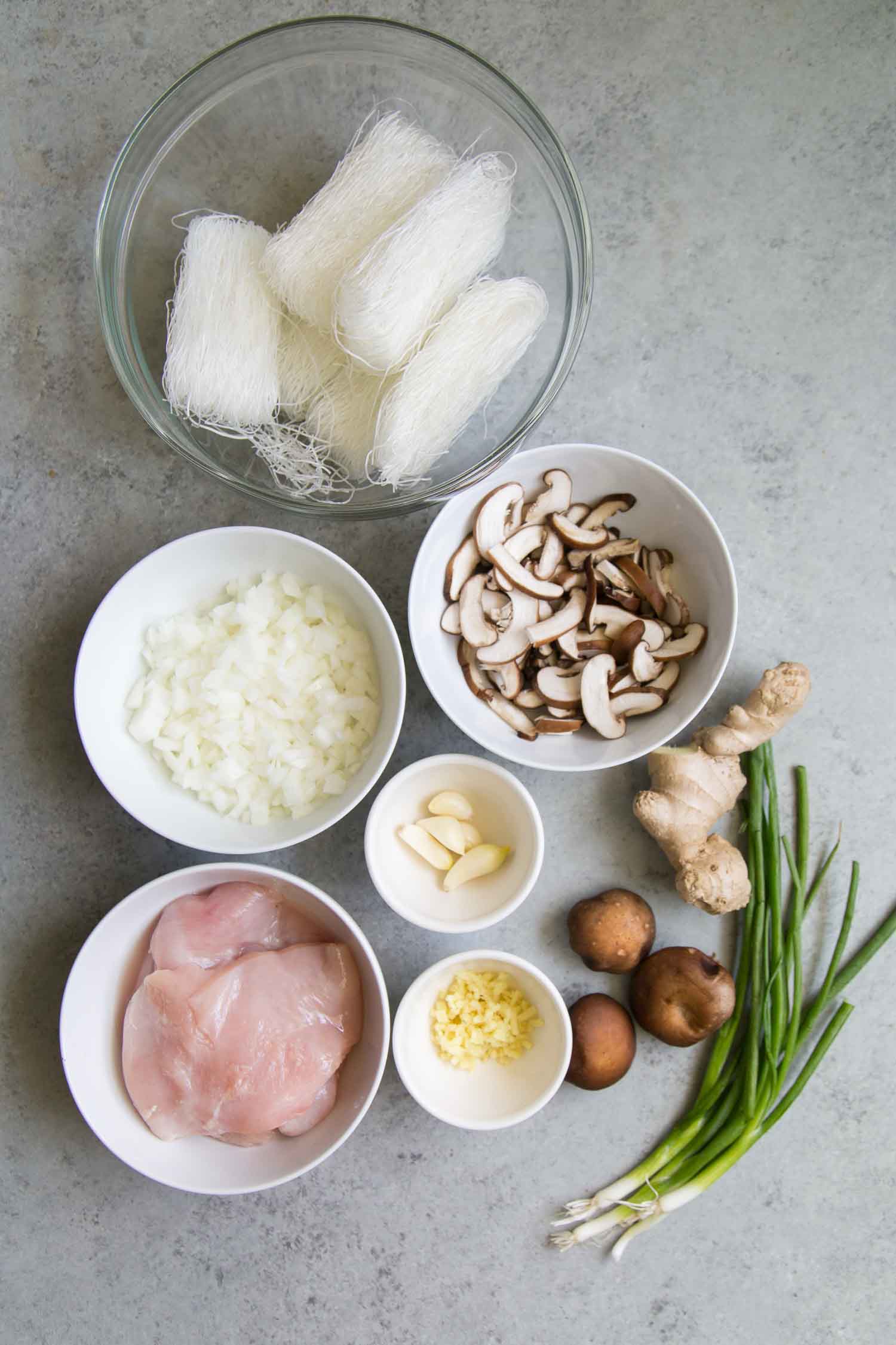 Chicken Sotanghon Soup ingredients include mung bean noodles, chicken, onion, garlic, and mushrooms. 