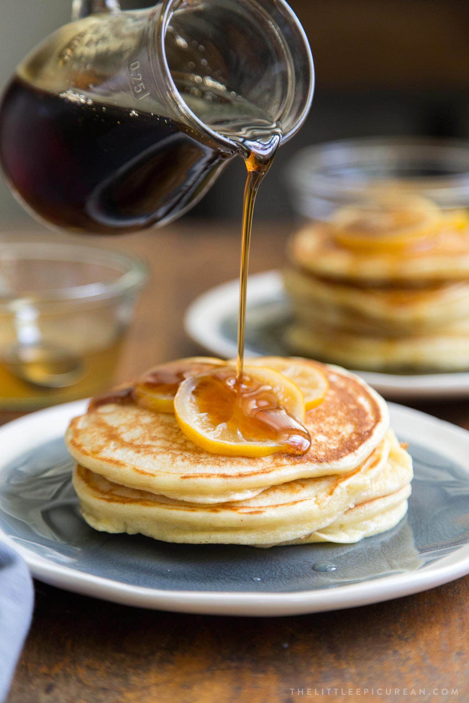 Meyer Lemon Ricotta Pancakes with maple syrup poured on top. 