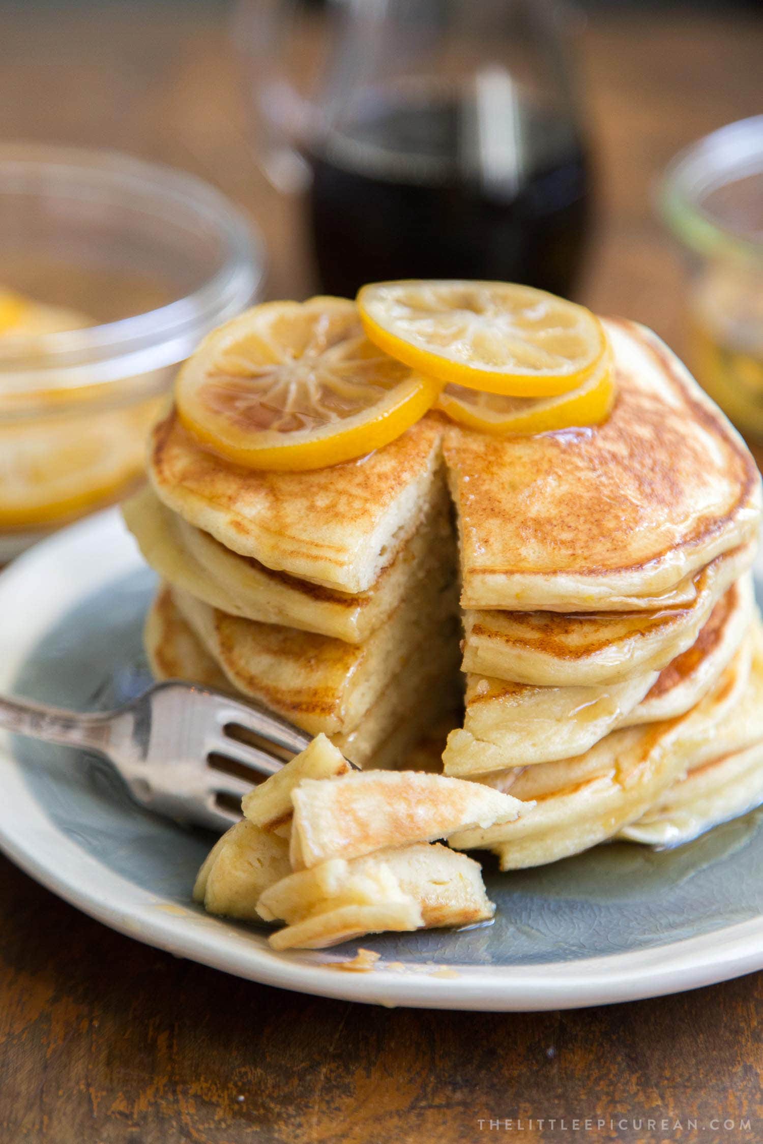 Meyer lemon ricotta pancakes stacked high topped with homemade candied meyer lemon slices. 