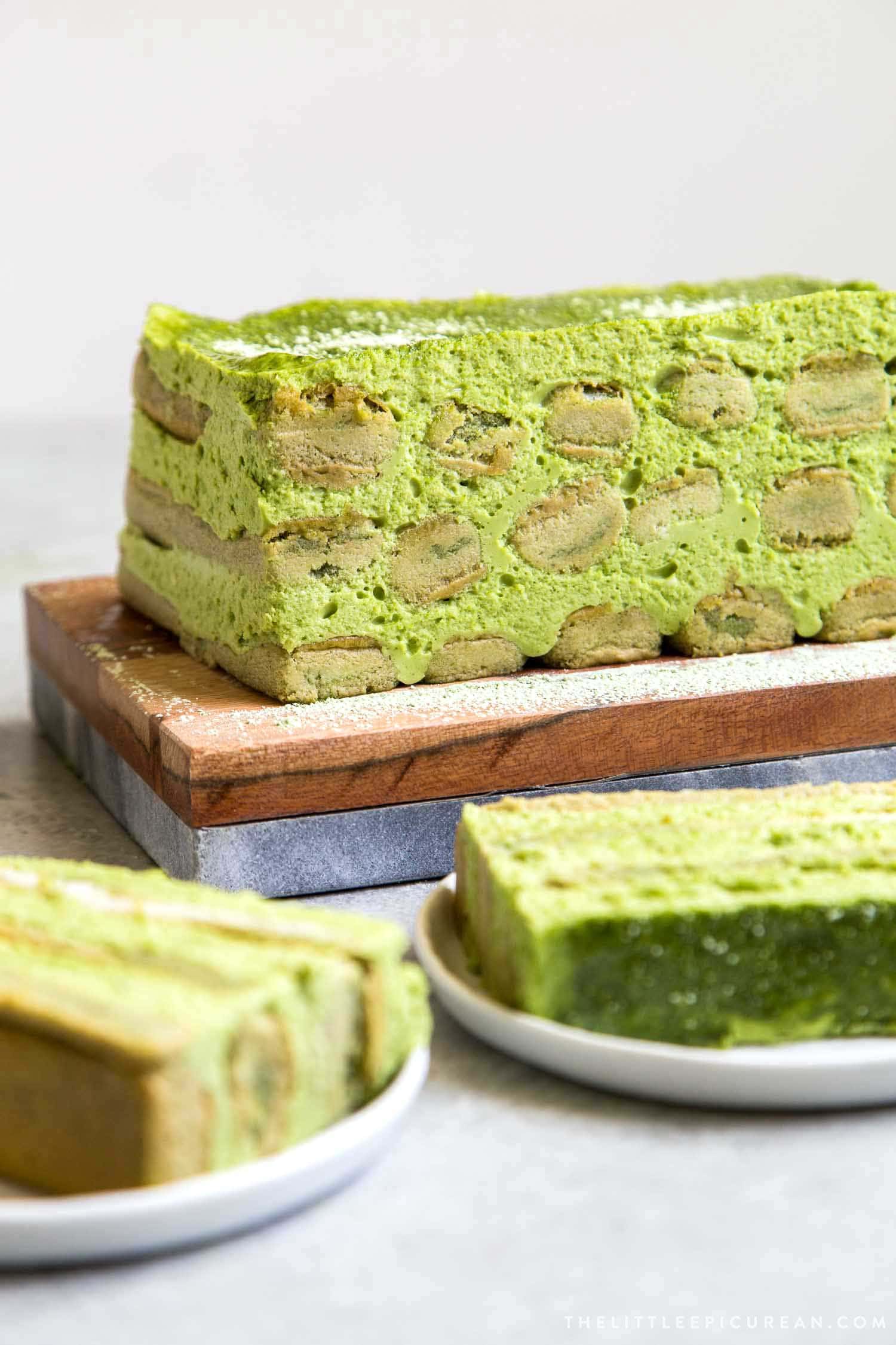 Matcha Tiramisu cake on wooden serving board. 