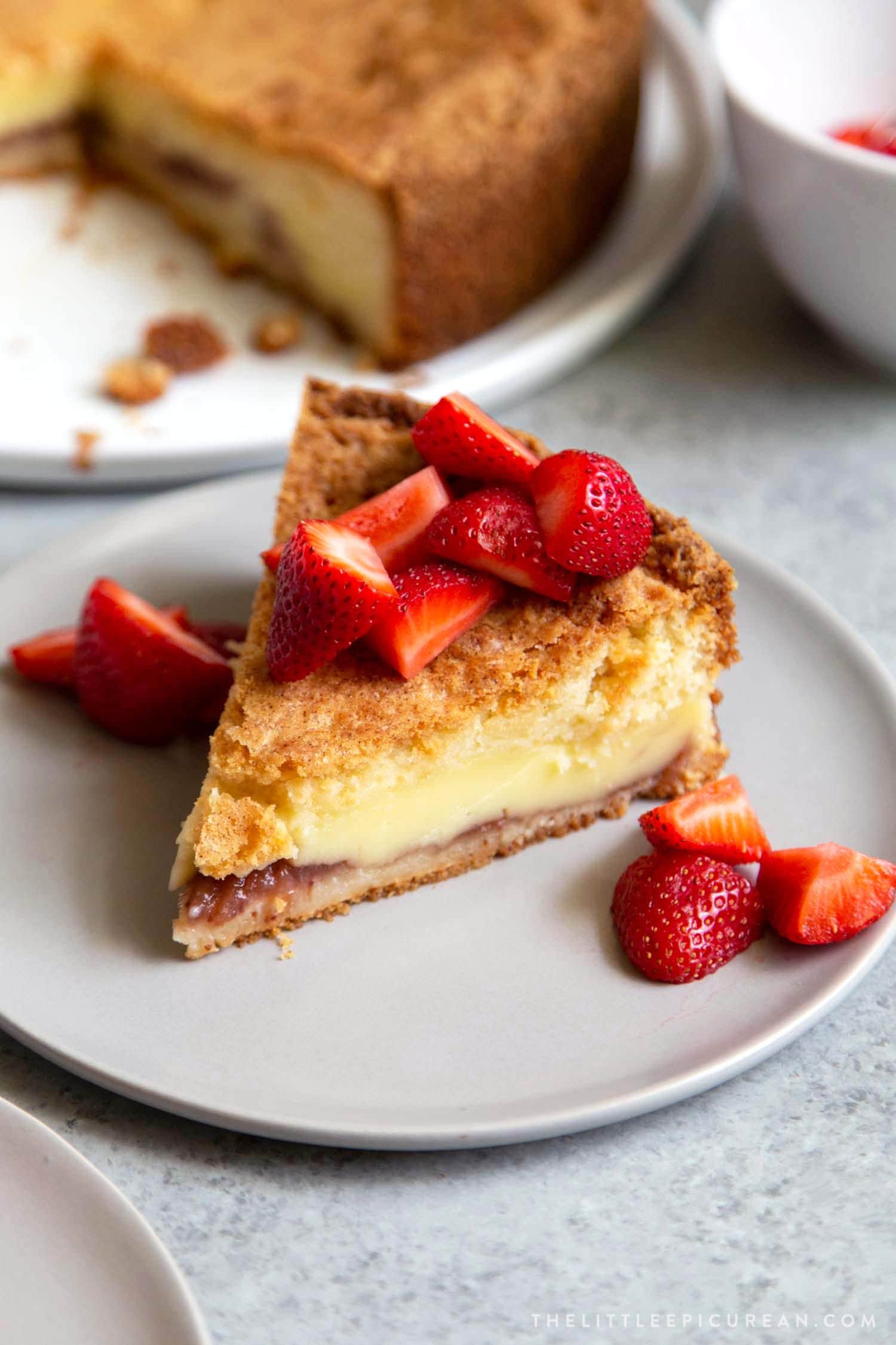 Basque Cake served with fresh strawberries. Basque cake is a buttery cake with a pastry cream filling. 