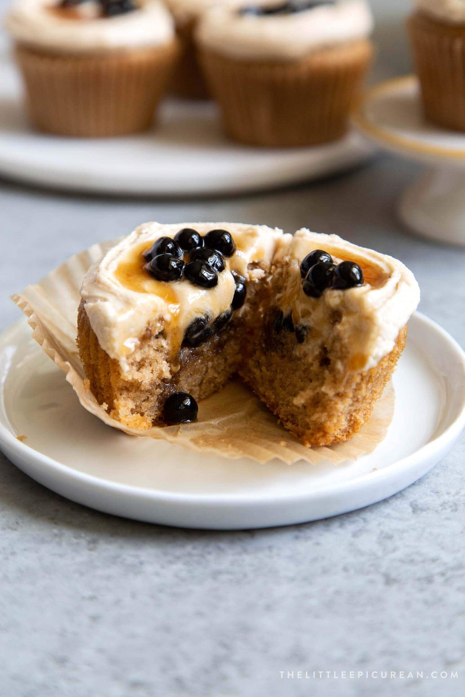 Interior shot of Boba Tea Cupcakes. Milk tea cupcakes filled with brown sugar boba and frosted with milk tea buttercream.