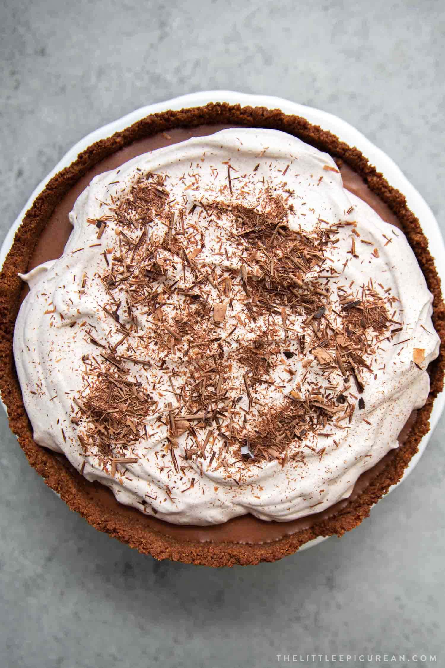 Chocolate Mousse Pie. Chocolate graham cracker crust filled with chocolate mousse and topped with whipped cream and chocolate shavings.