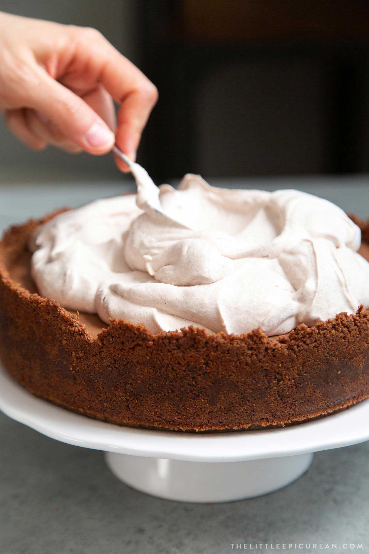 Chocolate Mousse Pie. Chocolate graham cracker crust filled with chocolate mousse and topped with whipped cream and chocolate shavings.