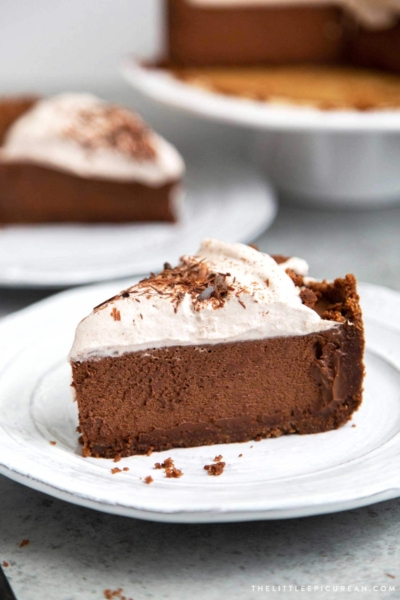 Slice of Chocolate Mousse Pie. Chocolate graham cracker crust filled with chocolate mousse and topped with whipped cream and chocolate shavings.