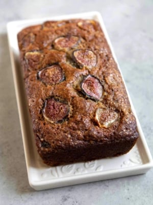 Fig Banana Bread. Brown sugar banana bread mixed with chopped figs in the batter and sliced figs on top to garnish.