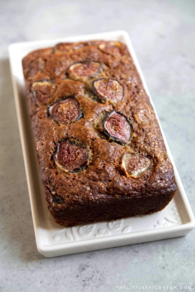 Fig Banana Bread. Brown sugar banana bread mixed with chopped figs in the batter and sliced figs on top to garnish.