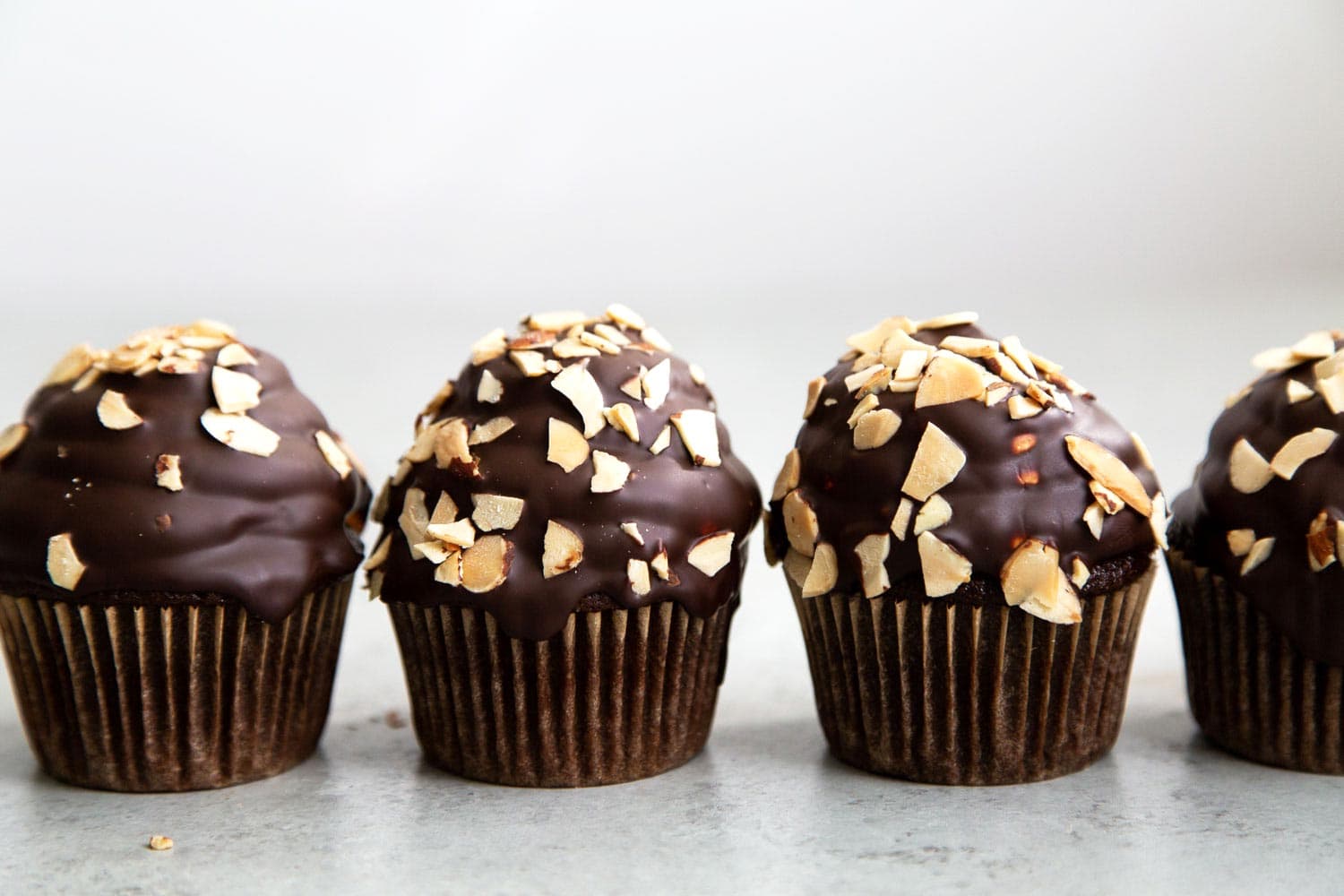 Almond Mocha Hi-Hat Cupcakes. Easy to make chocolate cupcakes topped with espresso meringue. It's dipped in chocolate and topped with toasted almonds.