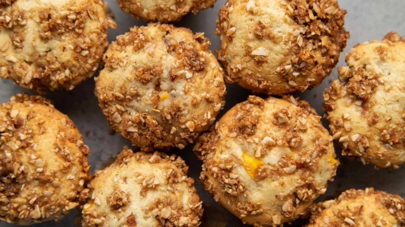 Almond Streusel Peach Muffins. Vanilla muffins mixed with fresh peaches and topped with almond streusel crumble.