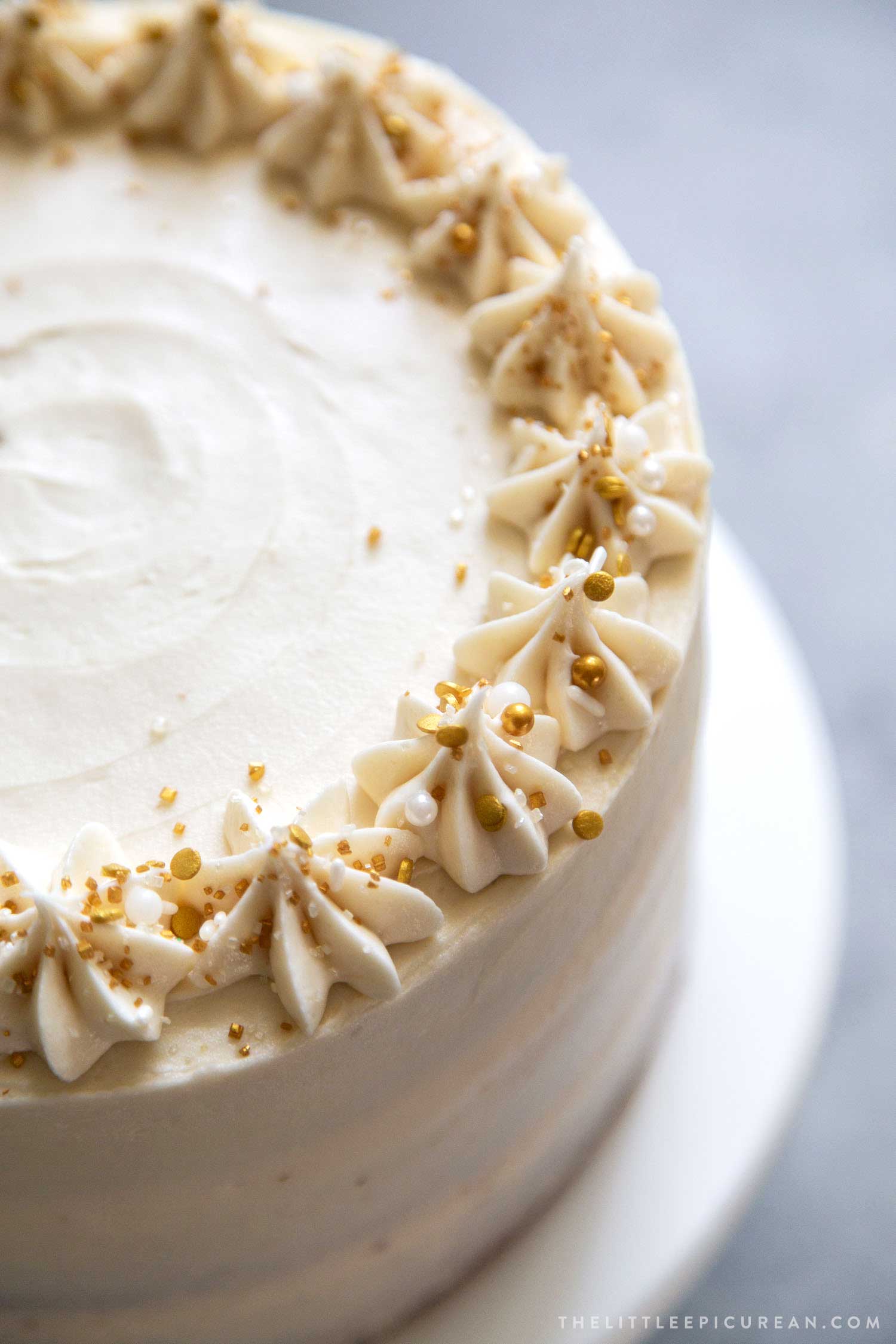 close up of apple cider cake topped with gold sprinkles.