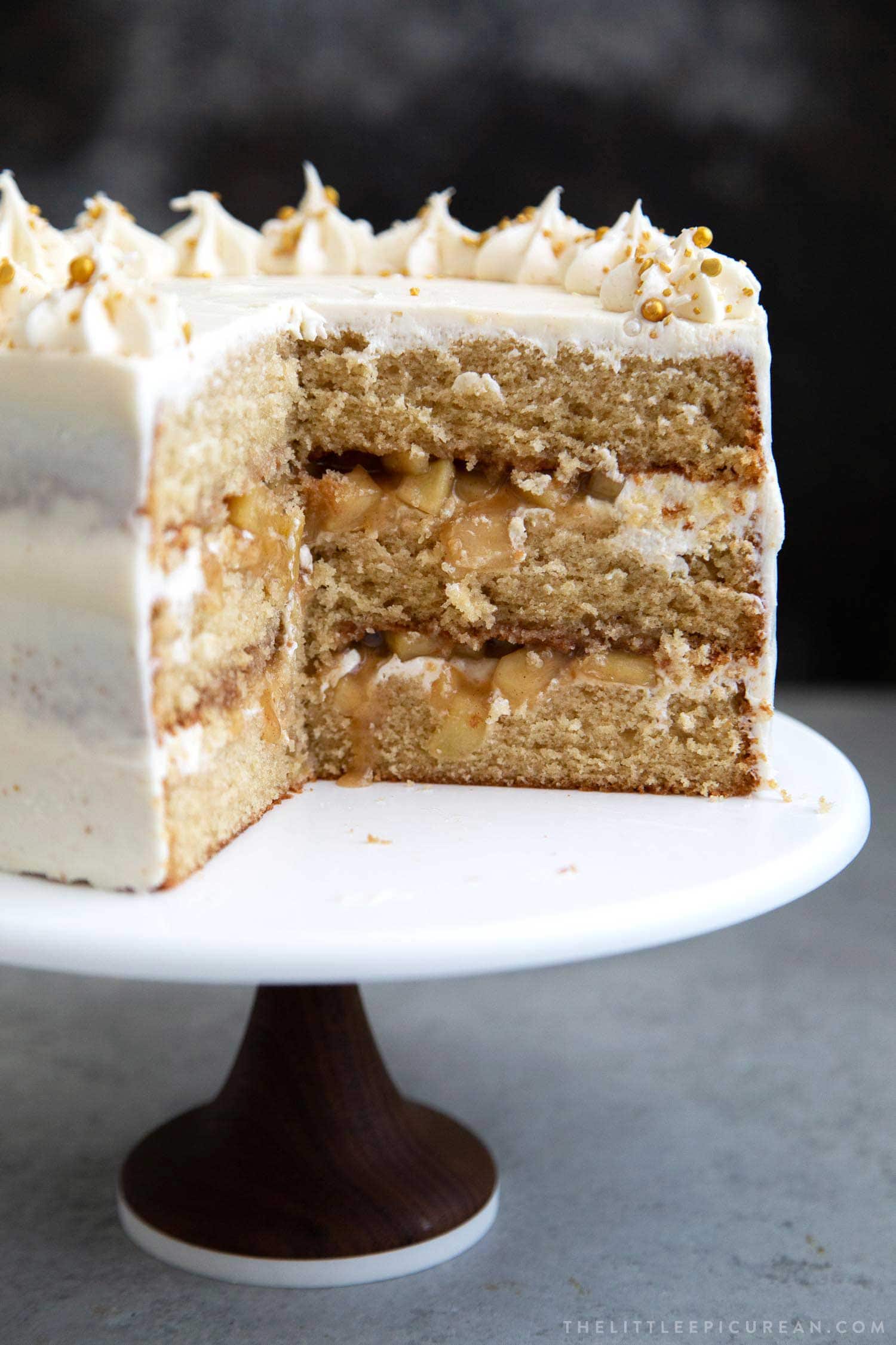 interior view of sliced apple cider cake showing cooked apple filling. 