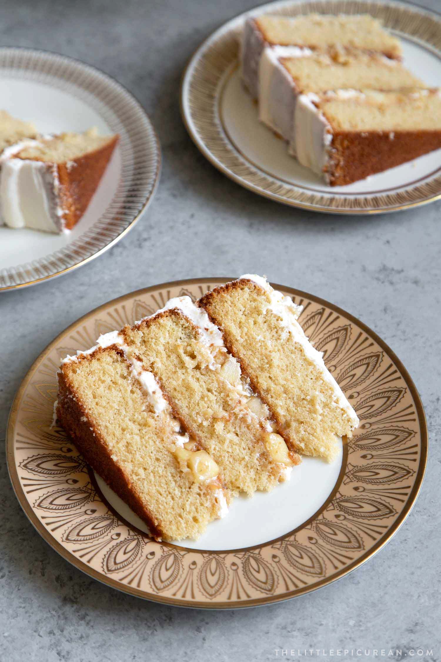 slice of apple cider cake with cooked apple filling.