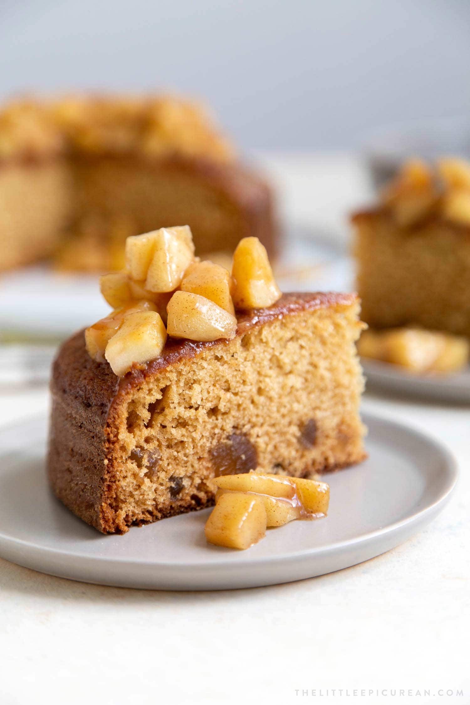 Apple Ginger Cake. Moist ginger cake is flavored with fresh grated ginger and candied ginger pieces. The baked cake is topped with ginger spiced apples and a drizzle of caramel.