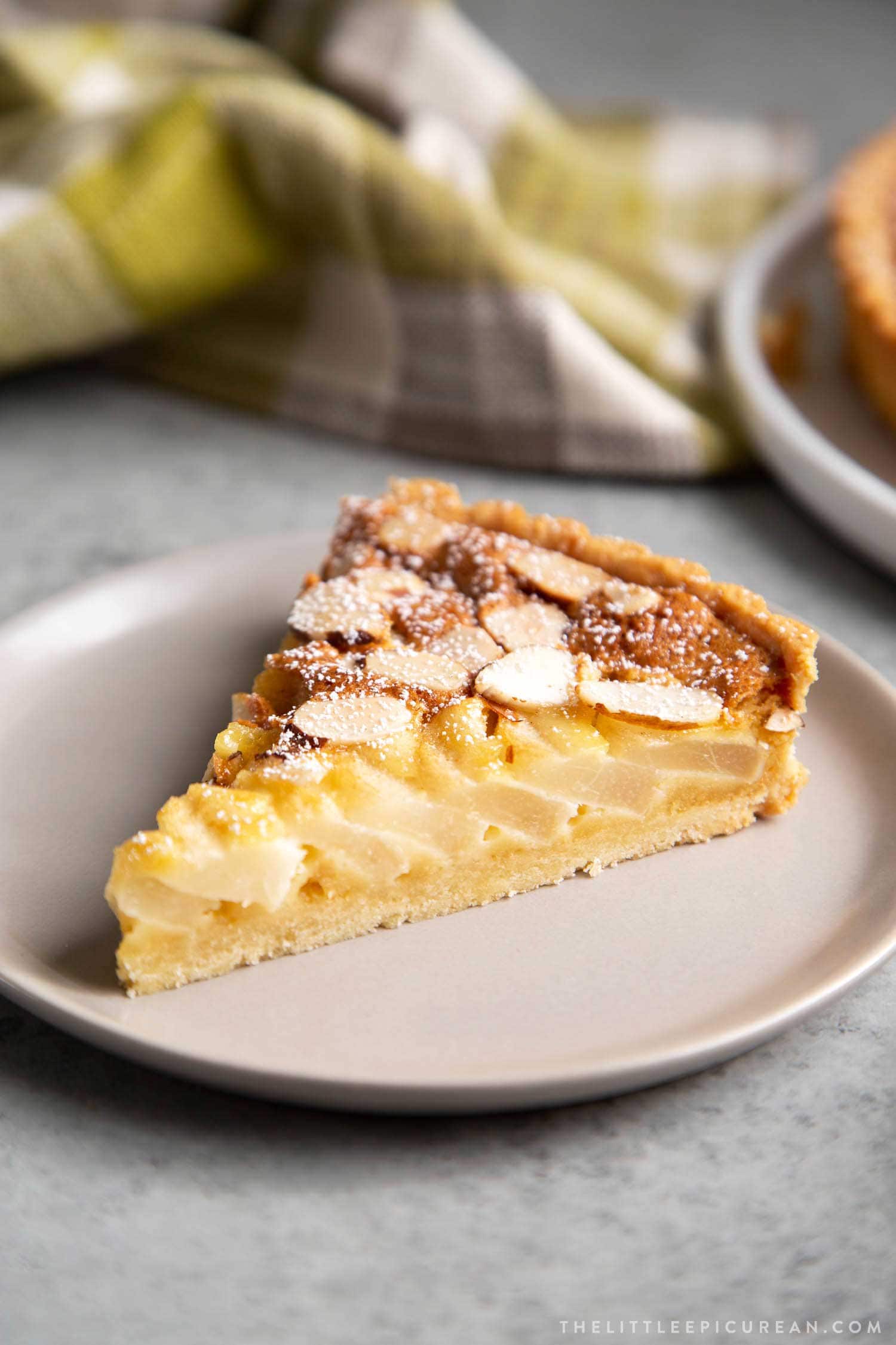 Pear Frangipane Tart Slice. Buttery shortbread crust baked with almond frangipane filling and pears.