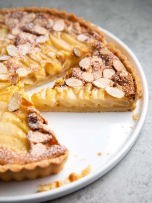 Pear Frangipane Tart Slice. Buttery shortbread crust baked with almond frangipane filling and pears.