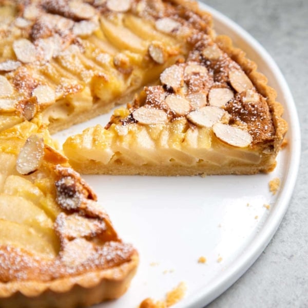 Pear Frangipane Tart Slice. Buttery shortbread crust baked with almond frangipane filling and pears.