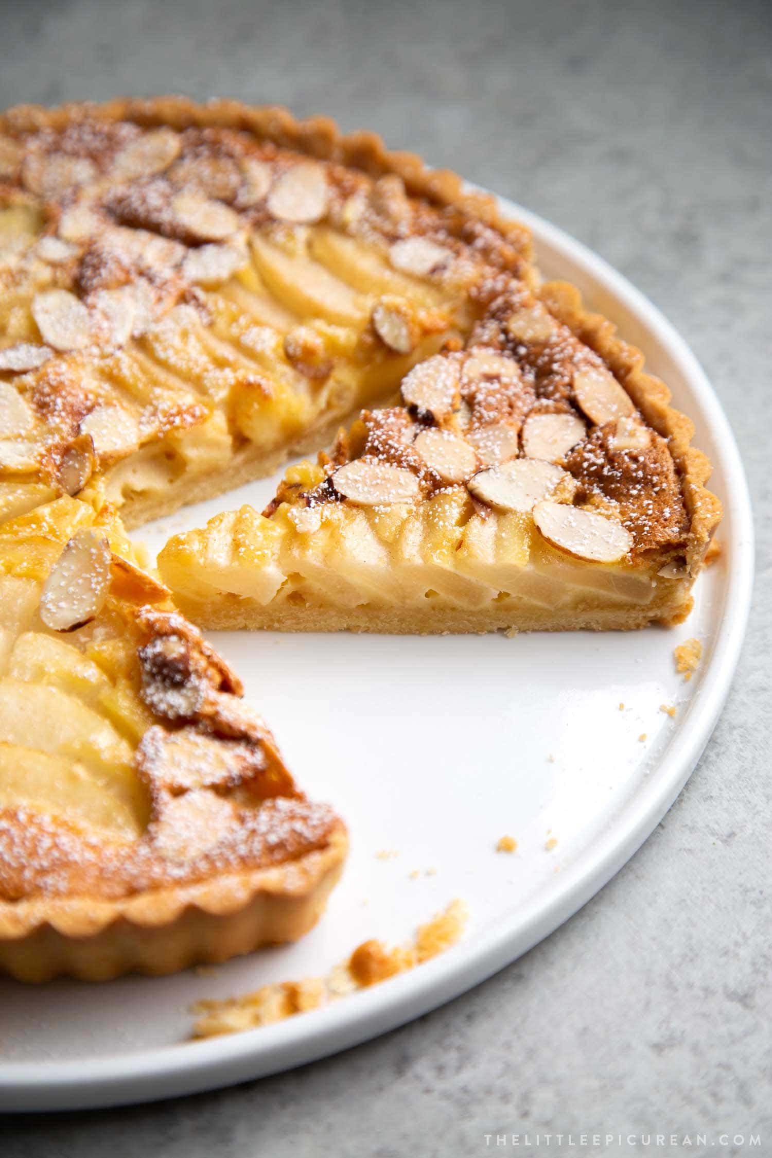 Pear Frangipane Tart Slice. Buttery shortbread crust baked with almond frangipane filling and pears.