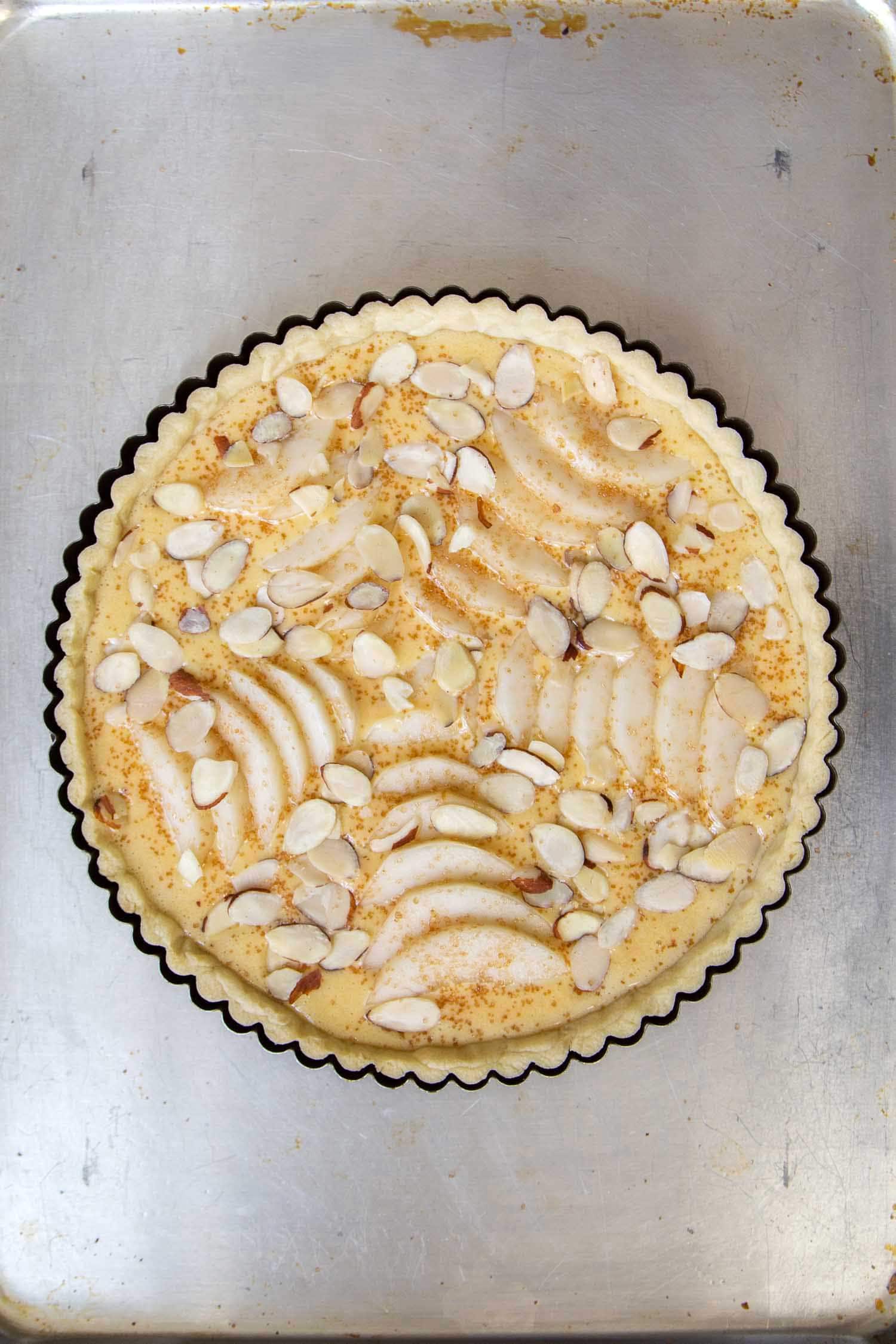 Pear Frangipane Tart. Pour homemade frangipane filling into par-baked tart shell. Then, arrange sliced pears and almonds on top.