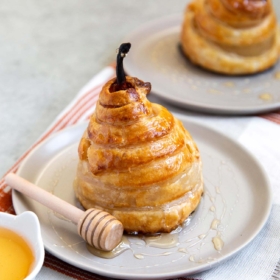 Poached Pear Puff Pastry. Pears poached in sweet vanilla cinnamon liquid. Encased in puff pastry and baked until golden. #pear #peardessert #falldessert #puffpastry
