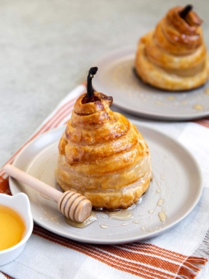 Poached Pear Puff Pastry. Pears poached in sweet vanilla cinnamon liquid. Encased in puff pastry and baked until golden. #pear #peardessert #falldessert #puffpastry