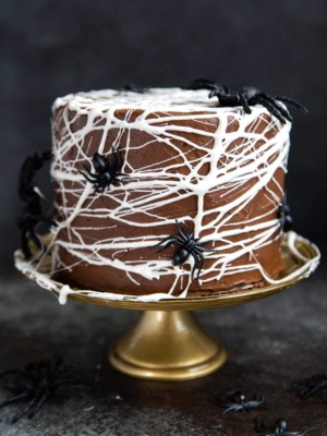 Chocolate Spider Web Cake. Three layer chocolate cake frosted with simple chocolate buttercream and decorated with marshmallow spider webs. It's the perfect Halloween treat!