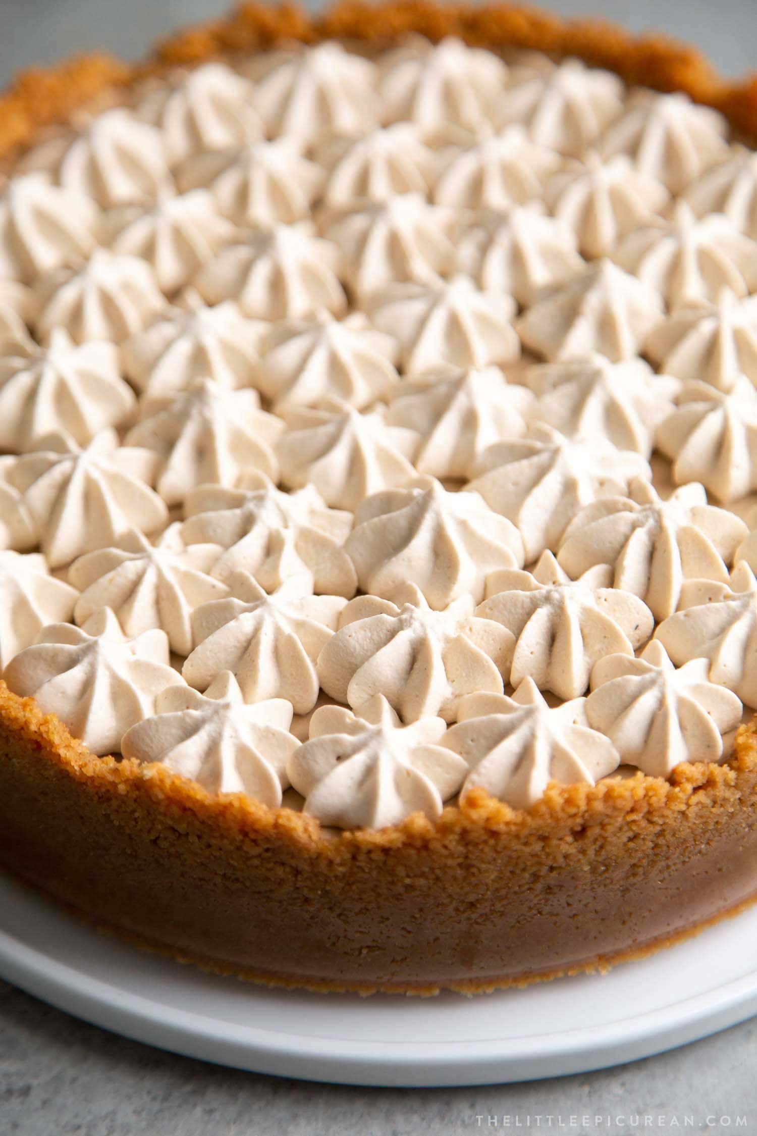 Coffee Mousse Cheesecake. Graham cracker crust, silky cheesecake layer topped with coffee mousse and whipped cream.