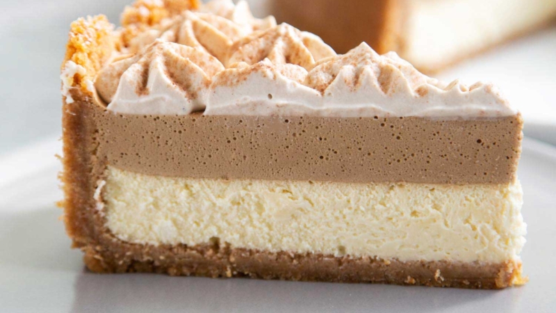 Coffee Mousse Cheesecake. Graham cracker crust, silky cheesecake layer topped with coffee mousse and whipped cream.