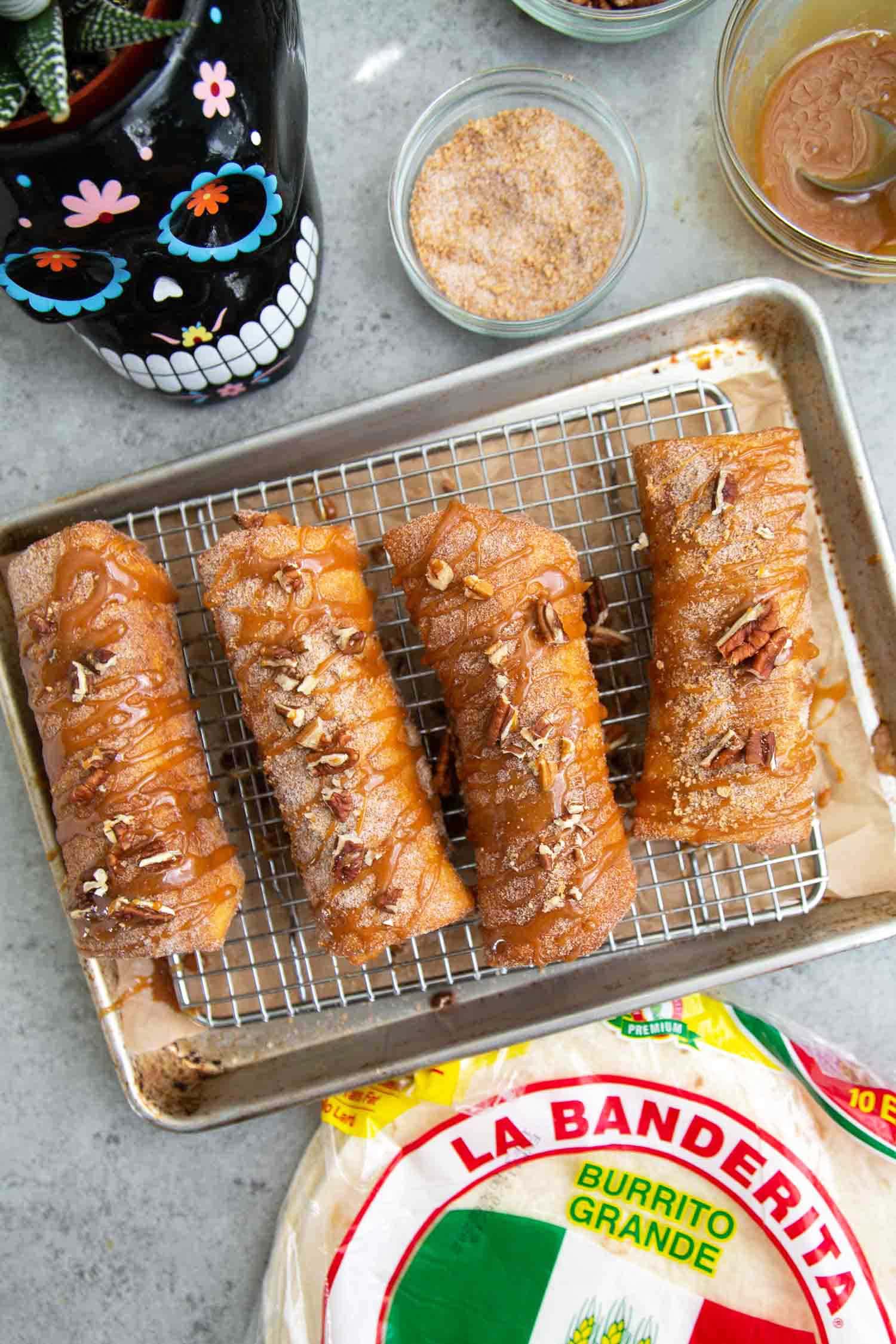 Pineapple Cheesecake Chimichangas. Crispy fried burritos filled with vanilla cream cheese and cinnamon spiced pineapple chunks. The dessert chimichangas are tossed in a sweet graham cracker powder.