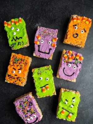 a variety of colorful Monster Marshmallow Cereal Treats on dark background.