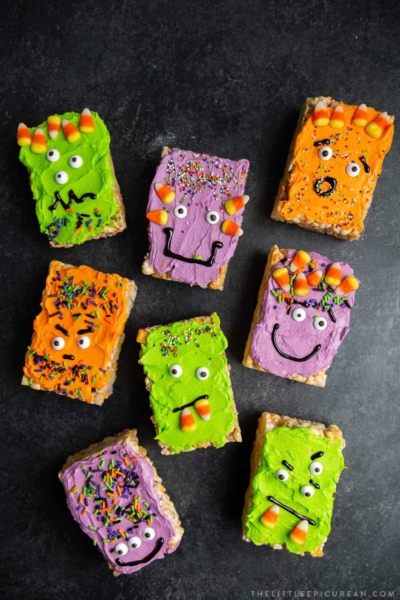 a variety of colorful Monster Marshmallow Cereal Treats on dark background.
