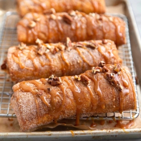Pineapple Cheesecake Chimichangas. Crispy fried burritos filled with vanilla cream cheese and cinnamon spiced pineapple chunks. The dessert chimichangas are tossed in a sweet graham cracker powder.