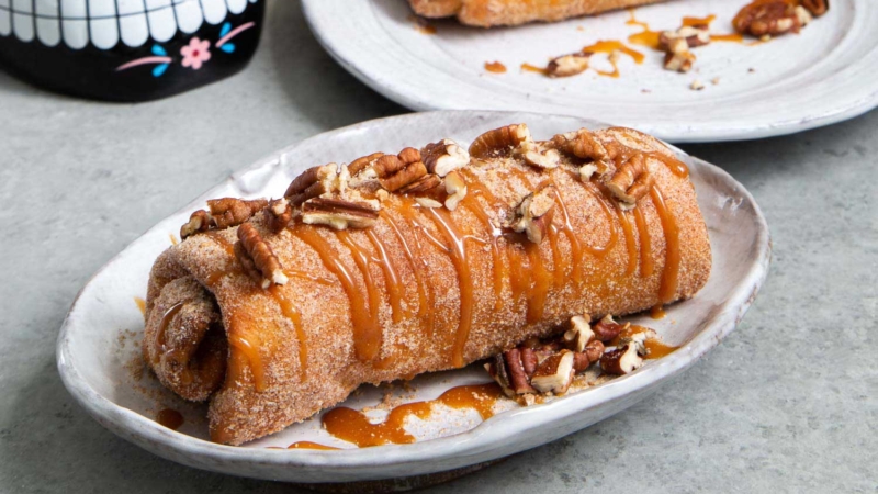 Pineapple Cheesecake Chimichangas. Crispy fried burritos filled with vanilla cream cheese and cinnamon spiced pineapple chunks. The dessert chimichangas are tossed in a sweet graham cracker powder.