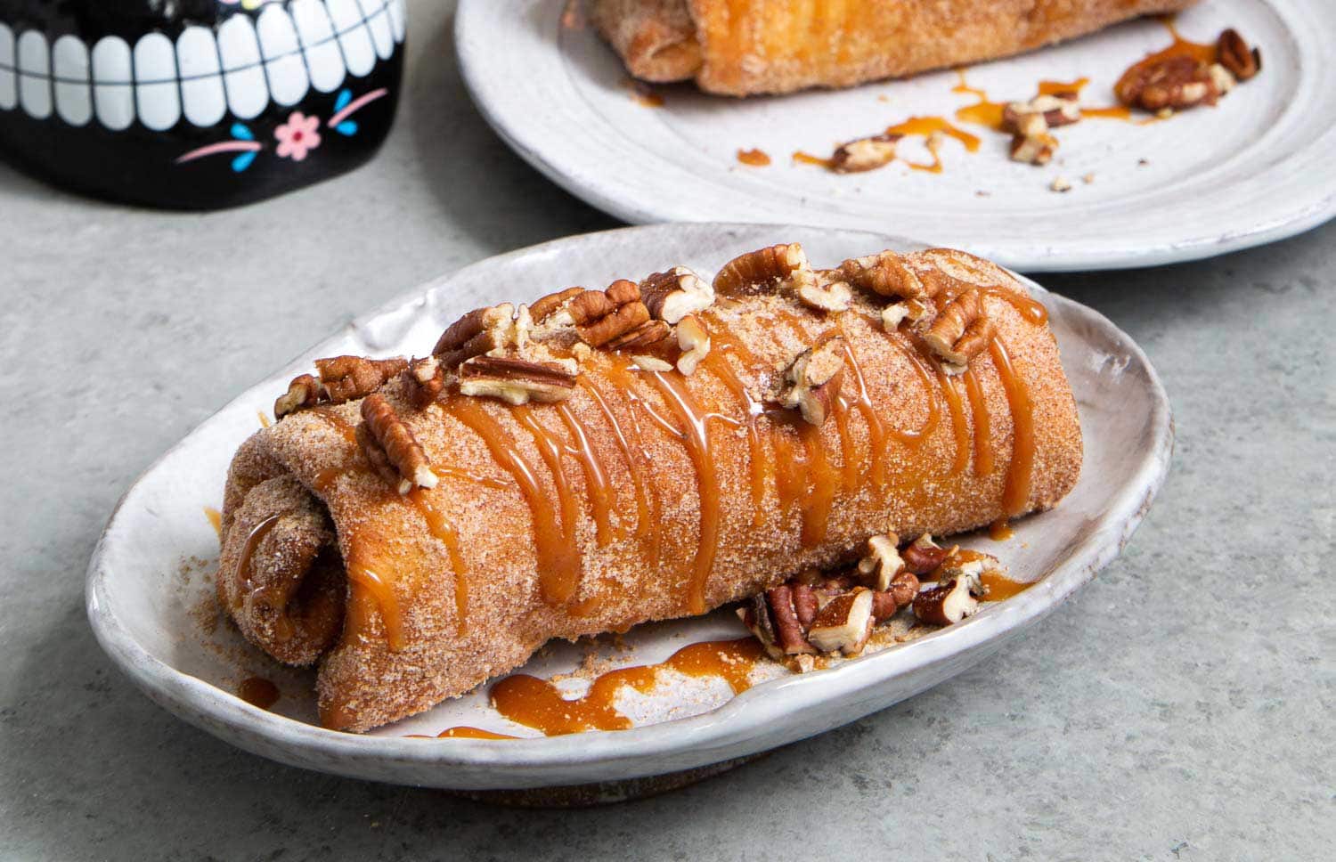 Pineapple Cheesecake Chimichangas. Crispy fried burritos filled with vanilla cream cheese and cinnamon spiced pineapple chunks. The dessert chimichangas are tossed in a sweet graham cracker powder.