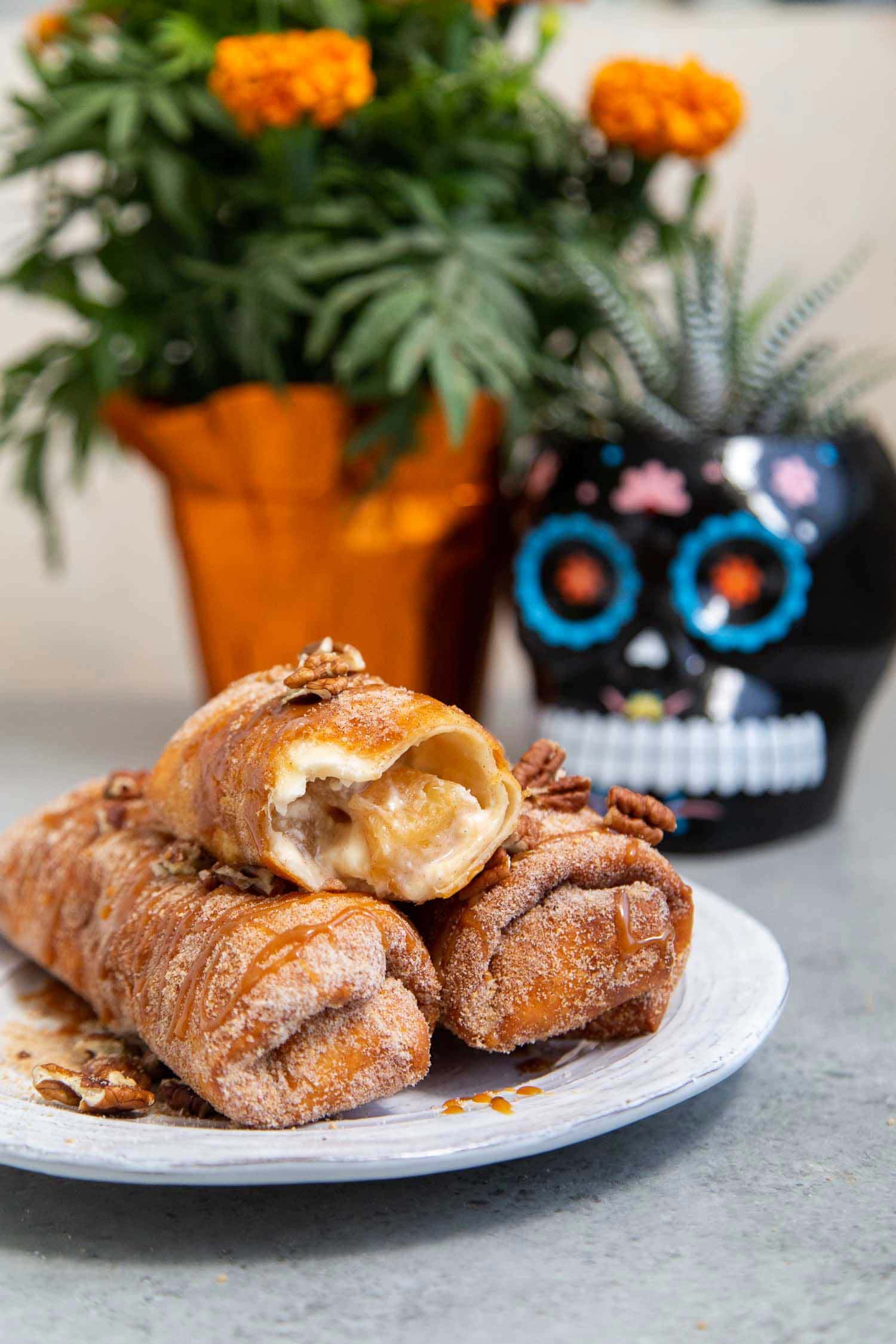 Pineapple Cheesecake Chimichangas. Crispy fried burritos filled with vanilla cream cheese and cinnamon spiced pineapple chunks. The dessert chimichangas are tossed in a sweet graham cracker powder.