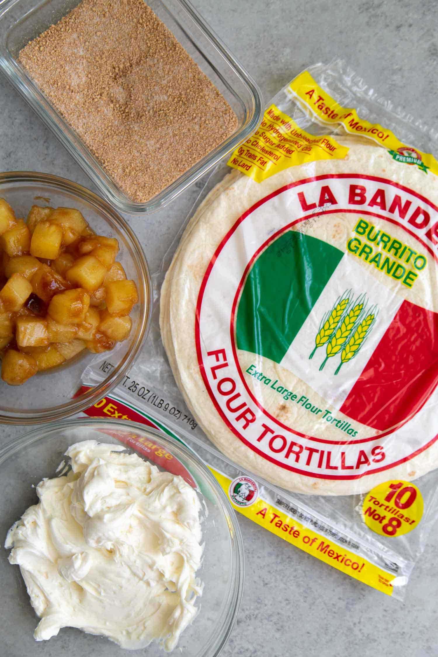 Ingredients needed for Pineapple Cheesecake Chimichangas: La Banderita 10-inch flour tortillas, vanilla cream cheese mixture, cinnamon spiced pineapples, and graham cracker crumb mixture