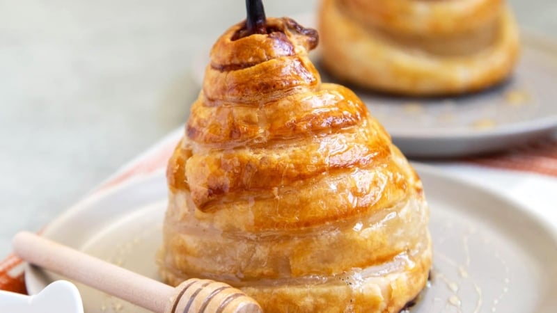 Poached Pear Puff Pastry. Pears poached in sweet vanilla cinnamon liquid. Encased in puff pastry and baked until golden. #pear #peardessert #falldessert #puffpastry